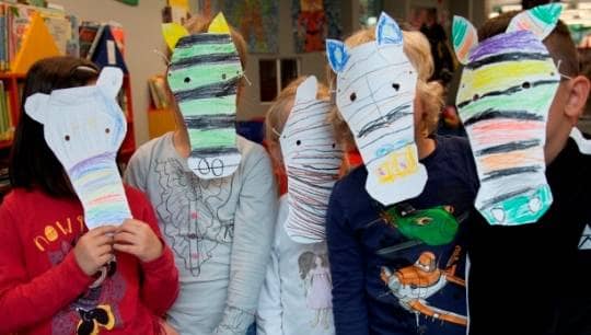 Kinder mit selbstgebastelten Masken